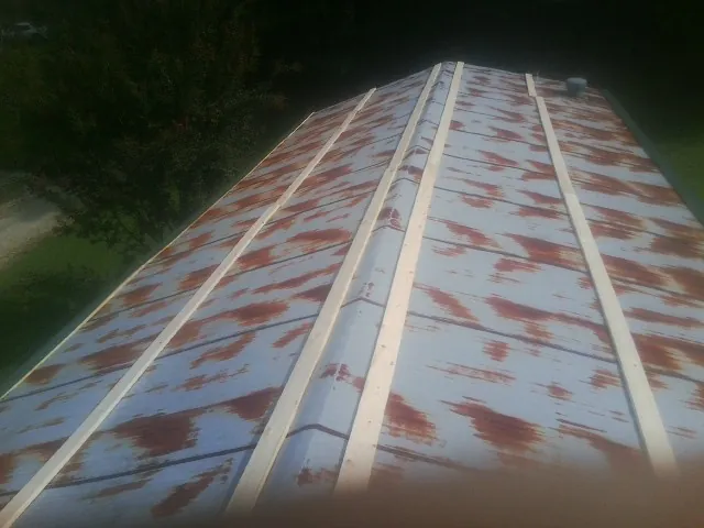 Rusted metal roof panels with new wood purlins before replacement — Storm Damage Roof Repair in Cache by Roofing Brothers